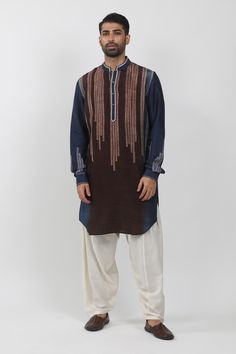 Indigo, brown colorblock kurta with leaf hand block print in stripe pattern and thread embroidered placket.
Components: 1
Pattern: Hand Block Printed, Embroidery
Type Of Work: Leaf, stripe, thread
Neckline: Band collar
Sleeve Type: Full sleeves
Fabric: Tussar
Color: Blue
Other Details: 
Front button detailing
Asymmetric hem
Cuff sleeve hem
Note: Pant worn by the model is not for sale
Occasion: Sangeet - Aza Fashions Unstitched Brown Traditional Wear With Resham Embroidery, Cotton Kurta With Dabka Work And Multicolor Embroidery, Cotton Kurta With Multicolor Embroidery And Dabka Work, Cotton Kurta With Multicolor Dabka Embroidery, Brown Traditional Wear With Dabka Work For Eid, Folk Style Long Sleeve Handloom Kurta, Multicolor Cotton Kurta With Dabka Work, Traditional Cotton Kurta With Woven Motifs, Brown Unstitched Kurta With Dabka Work