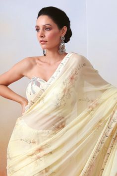 White lined saree with floral print and embroidered border. Paired with zardozi, mirror embroidered bordered padded bustier and petticoat.
Component: 3
Pattern: Printed, Embroidery
Type Of Work: Floral, zardozi, mirror
Neckline: Sweetheart
Fabric: Chiffon, Silk
Color: White
Other Details: 
Strapless bustier
Smocked back
Occasion: Reception - Aza Fashions Bollywood Style Pre-draped Saree With Sheer Dupatta For Summer, Traditional Pre-draped Saree For Summer Reception, Summer Wedding Pre-draped Saree With Zari Work, Summer Wedding Pre-draped Saree With Sheer Dupatta, Georgette Saree With Floral Embroidery For Wedding, Summer Georgette Saree With Dupatta, Summer Georgette Pre-draped Saree With Zari Work, Floral Embroidered Georgette Saree For Wedding, Summer Pre-draped Georgette Saree With Sheer Dupatta