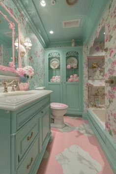 the bathroom is decorated in pastel blue and pink colors with flowers on the walls