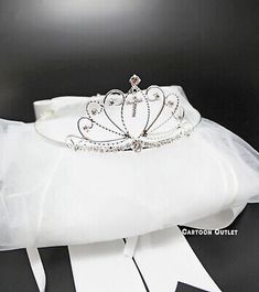 a tiara is sitting on top of a white pillow