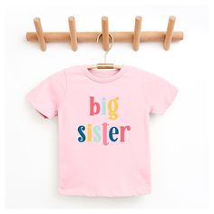 Looking for a cute tee for your kids? We have the perfect Big Sister Colorful graphic tee addition to their closet! Also available in youth tees. Cute Multicolor T-shirt With Name Print, Playful Short Sleeve T-shirt With Text Print, Playful Pink T-shirt With Graphic Print, Playful Pink Graphic Print T-shirt, Pink Family Matching T-shirt With Letter Print, Family Matching Pink T-shirt With Letter Print, Family Matching Multicolor Cotton T-shirt, Playful Pink Tops With Name Print, Family Matching Multicolor Graphic T-shirt