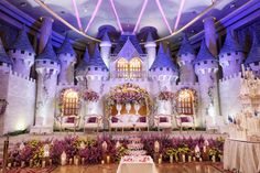 a castle decorated with flowers and candles for a wedding