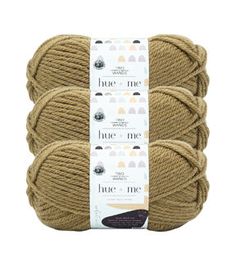 three skeins of yarn in beige colors