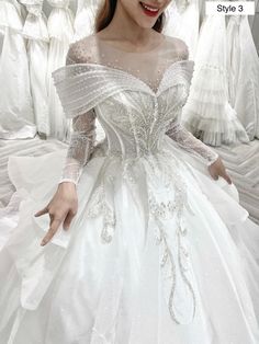 a woman in a white wedding dress posing for the camera