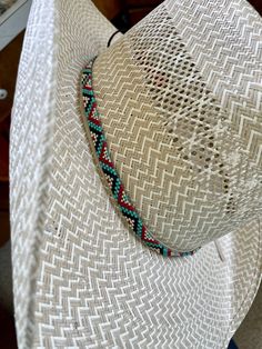 "1/4\" wide All bead work is beaded with 10lb extreme braided nylon line. All hat bands are finished at 23\" with glued than sewed down leather ends and an adjustable leather tie." Handwoven Hat Bands For Rodeo With Flat Brim, Western Handwoven Hat Bands For Rodeo, Traditional Adjustable Jewelry For Rodeo, Adjustable Handwoven Hat Bands For Rodeo, Western Style Adjustable Handwoven Hat Band, Traditional Adjustable Hat Bands For Rodeo, Adjustable Beaded White Hat Bands, Adjustable Braided Hat Bands For Rodeo, Traditional White Adjustable Hat Bands