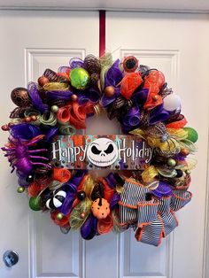 a halloween wreath with the words happy holidays on it