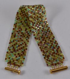 a pair of gold tone metal clips with multicolored glass beads