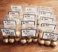 chocolates wrapped in plastic bags with labels on them sitting on a wooden table next to each other