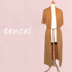 "*Long open cardigan with shawl collar and summery half-length sleeves. Removable waist cord. Made of very supple Tencel, soft and shiny and feeling as silk.   *FABRIC; 95 % Tencel (CLY)  5% elasthan. Tencel (Lyocell) is a relatively new fabric. This fabric has the luxurious feel of silk, is very strong and even better  moisturing than cotton. It's just like viscose made from cellulose (wood chips of the eucalyptus tree) and is therefore also called \"the new viscose\". The production process ( Brown V-neck Summer Cardigan, Stretch Open Front Cardigan For Beach, Summer Open Front Layering Shrug, Summer Layering Open Front Shrug, Summer Open Front Shrug For Layering, Long Stretch Cardigan For Spring, Beige Shawl Collar Cardigan For Spring, Spring Beige Cardigan With Shawl Collar, Summer Short Sleeve Stretch Cardigan