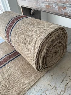 a rolled up rug sitting on top of a wooden floor