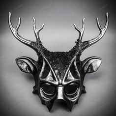 Mystery And Allure With Our Antler Deer Textured Horn With Brushed Silver Laces Devil Halloween Masquerade Mask In Black. Perfect For Anyone Seeking An Unforgettable Halloween Costume Or Masquerade Accessory, This Mask Combines The Wild Elegance Of Antler Deer Horns With The Mysterious Charm Of A Masquerade. Crafted From Durable Plastic, The Mask Features A Textured Design That Mimics The Aged Look Of Antique Artifacts, Painted In A Popcorn Textured Black To Enhance Its Appeal. Measuring Approxi Gothic Horned Masquerade Mask For Costume Party, Horned Masquerade Mask For Halloween, Fantasy Horned Masks And Prosthetics For Party, Punk Masquerade Mask For Halloween Party, Punk Style Masquerade Mask For Halloween Party, Punk Style Halloween Masquerade Mask For Party, Horned Masks And Prosthetics For Halloween Party, Halloween Party Horned Masks And Prosthetics, Horned Masquerade Mask For Halloween Costume Party