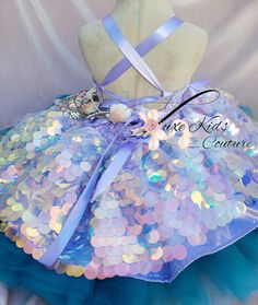 a dress made out of sequins and ribbons