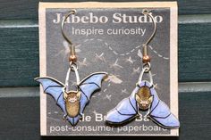 Jabebo Earrings  Hand-made in the USA (PA)  Contains post-consumer cereal box paperboard, a protective clear coat, and surgical steel hangers  Unique designs inspired by Science, Nature, and the World We Live In.Honey Creek Bill & Beak stocks over 100 different species of birds and critters in the Jabebo Earring line. Thanks for looking. Little Brown Bat, Bird Earrings, Handcrafted Artisan Jewelry, Clear Coat, Bird Species, Artisan Jewelry, Cereal Box, Shopping List, Hangers