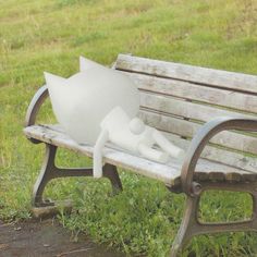 a white sculpture sitting on top of a wooden bench