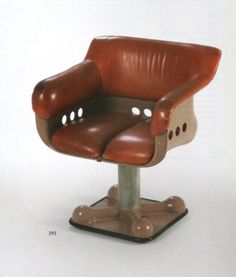 a brown leather office chair sitting on top of a metal base with holes in the back