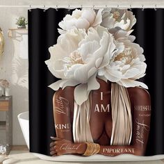 a shower curtain with two bottles and flowers on the top, in front of a bathtub