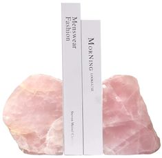 two pink rocks sitting next to each other in front of a white box with the words mooning written on it