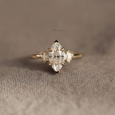 an engagement ring with three stones on it