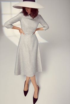 A beautifully structured Italian metallic tweed dress inspired by a classic 1950s silhouette.

The cloth of the dress has a soft powder blue base woven together with soft silver metallic threads. 1950s Silhouette, Suzannah London, Midi Dress Winter, Formal Dresses With Sleeves, Sophisticated Outfits, Winter Sky, Black Tie Affair, Vintage Couture, Cowl Neckline