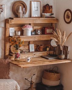 a wooden shelf filled with lots of items next to a wall covered in pictures and photos