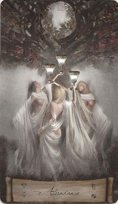 three women dressed in white are standing under a tree with two candles on their heads