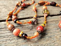 "------------------------------------------------------------------- Long Orange Necklace handmade by reccabella ------------------------------------------------------------------- This long necklace is a great piece, I have made it from hundreds of different beads in various shades of orange. The mixture of materials such as wood, glass, ceramic etc makes this a really interesting necklace. The variations of shade also adds to the uniqueness of the piece. I have added some antique bronze effect Orange Bohemian Beaded Necklaces For Jewelry Making, Bohemian Orange Beaded Necklaces For Jewelry Making, Bohemian Orange Long Necklace, Bohemian Multi-strand Necklace With Spacer Beads, Bohemian Long Necklace With Round Beads For Gifts, Bohemian Orange Beads For Gifts, Bohemian Orange Beaded Chain Necklace, Handmade Round Beads Long Necklace For Festival, Bohemian Orange Necklaces With Wooden Beads