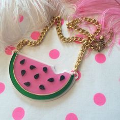 "This is a scrumptious necklace for all seasons! Bring the fun to any outfit with this big and bold watermelon necklace. This original design has been laser cut out of a mix of glitter, mirror, and opaque 1/8\" acrylic sheet and is backed with white, 1/16\" acrylic. The necklace hangs from a thick, gold chain and measures about 16\". We love these necklaces and think that they never get old. However, to prolong the life of yours, treat it with love! Be careful when storing it in a bag or pocket Cute Pink Resin Necklace, Fun Summer Necklaces For Gifts, Cute Summer Party Necklaces, Cute Party Necklaces For Summer, Trendy Resin Necklaces For Party, Fun Resin Jewelry For Parties, Pink Resin Party Necklaces, Fun Resin Jewelry For Party, Fun Resin Party Jewelry