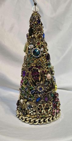 a christmas tree made out of jewelry on a white background