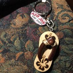 a wooden keychain with a dog's paw on it