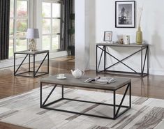 two coffee tables sitting on top of a wooden floor next to each other in front of a window