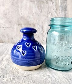 two blue jars sitting next to each other