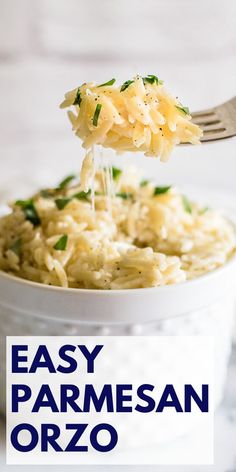 a white bowl filled with pasta and parmesan cheese being held by a fork