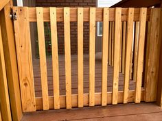 a wooden gate is open on the front porch