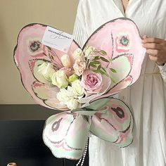 a woman holding a bouquet of flowers in her hands