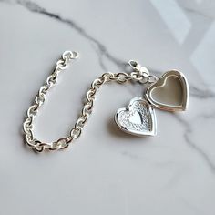 Sterling silver plated charm bracelet with beautiful heart locket  Locket opens for picture inserts of your loved one ! Bracelet is adjustable from 16 cm to 20 cm Heart is about 3cm across Heart is stamped  Great gift for the holidays sterling silver plating on stainless steel Picture Locket, Heart Pictures, Locket Charms, Heart Locket, Lovely Earrings, Beautiful Heart, Sterling Silver Heart, Memorial Gifts, Bracelet Gift