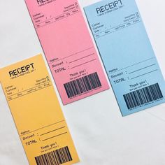 two tickets with barcodes on them sitting next to each other