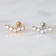 Discover elegance with our dainty CZ ear climber studs. Minimalist, petite, and timeless, these handcrafted earrings add subtle sophistication to your style. ■ DETAILS ■ 10mm 20G Back Length: 8mm Back type: Ball backs Paved with AAAAA Grade Cubic Zirconia Material: 18K gold plated over implant grade titanium Ti-6AL-ELI Hypoallergenic jewelry; Nickel Free & Lead Free READY TO SHIP IN 1 DAY FREE SHIPPING from New York - VIVIDORA | Classic Cz Ear Climber, Gem Cluster Studs, Tragus Earrings Gold, Go Gem Cluster, Gold Ear Climbers, Ear Crawlers, Ear Climber, Tragus Earrings, Ear Climbers, Hypoallergenic Jewelry, Handcrafted Earrings, Tragus