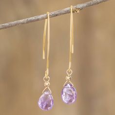 Two lavender cubic zirconia grace these slender earrings to create delicate drops. They are the creation of Costa Rican fine artist Guisselle Mora whose love for earrings and more came from the treasures she saw in her grandmother's jewelry box. The stainless steel is bathed in radiant 18k gold for timeless glamour. Raindrop Earrings, Grandmother Jewelry, Lavender Earrings, Timeless Glamour, Costa Rican, Hair Jewelry Wedding, Fine Artist, Dangly Earrings, Rain Drops