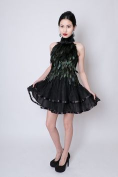 Qi Pao, Chinese inspired black feather dress with mandarin collar and Asian clasp at throat. Each feather is carefully trimmed and hand applied to a natural kona cotton dress base. Feathers are originally green and gold and dyed black. They have a glossy iridescent sheen and the green and gold tones can be seen in bright sunlight and flash photography. Skirt is soft layers of black tulle with ribbon detailing. Zipper closure in black.This dress is made to measure. Please contact me for custom si Peacock Feather Dress, Black Feather Dress, Qi Pao, Ballerina Skirt, Black Tulle, Feather Dress, Love Clothing, Wedding Gowns Lace, Fashion Designs