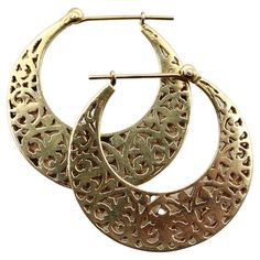 A very special pair of 14k gold vintage hoops that, when viewed from the side, are shaped like crescent moons. The earrings have a reticulated pattern that’s based on a fleur-de-lys motif. They consist of two layers of gold sandwiched on top of each other, which gives the illusion of depth, allowing you to see through to the pattern on the opposite side. The moon-shape and layered gold have the feel of exotic travels, making these a wonderful pair of vintage earrings perfect for any occasion. Fo Moon Shape, Moon Shapes, Pierced Ears, Vintage Earrings, Ear Piercings, Crescent, Jewelry Earrings, Hoop Earrings, Moon