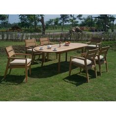 an outdoor table and chairs in the grass