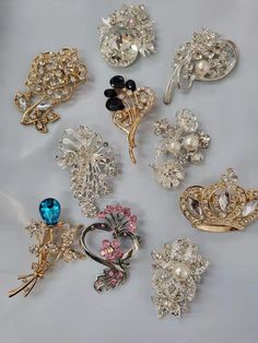 "This listing is for mix lot 10 rhinestone pearl brooch pins for DIY wedding project Note: Brooch pins will be picked randomly (not necessarily as pictured) Size: Approximately 3\" x 2\". Smallest size is 1.5\" x 1.5\" Here at CaSales, we take pride in providing you with high quality products with low pricing, quick delivery, and world class customer service. Your satisfaction is our top priority." Rhinestone Pins For Wedding, Wedding Pins With Rhinestones, Bouquet Hat, Wedding Cake Flower, Crown Butterfly, Cake Flower, Mystery Bag, Gold Brooch, Wedding Brooch