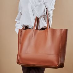 A highly functional holdall, this leather tote will carry all your essentials throughout the day. Boasting a soft, leather in a gorgeous deep color tone, complete with sturdy leather handles and an inner zip pocket for added security. Handmade in Italy 100% from NATURAL genuine leather The bag comes with a small pouch on the inner part of the bag (zipper), and without any linings fabrics (natural leather lining). Professional craftsmanship and excellent quality, soft touch but strong genuine leather! Width: 17.7 inch / 45cm Height: 13.9 inch / 35,5cm Depth: 3.9 inch / 10cm Standard handles height: 8.6 inch/22 cm Weight: 10oz / 300grams FEATURES -Inside zip pocket -Inside leather slots -Padded leather handles -Suede raw interior lining -Easy hand and shoulder carrying -Italian materials & w Soft Leather Tote Travel Bag For On-the-go, Versatile Tote Bag With Smooth Grain, Versatile Smooth Grain Tote Bag, Everyday Satchel Travel Bag In Textured Leather, Cognac Tote Travel Bag For Everyday Use, Rectangular Cognac Travel Bag For Everyday Use, Cognac Rectangular Travel Bag For Everyday Use, Cognac Travel Bag For Everyday Use, Everyday Cognac Tote Travel Bag