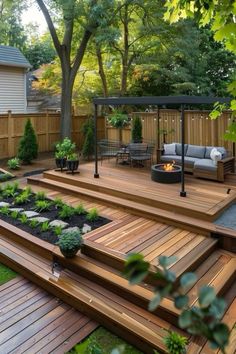 a wooden deck with steps leading up to a fire pit