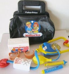 an assortment of medical supplies sitting on top of a white table next to a black bag