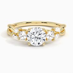 a yellow gold engagement ring with three stones