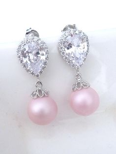 This earring features a rare and beautiful matt soft blush light round pink pearl (10 mm) , dangle from a white gold plated cubic zirconia earwire. Simple and yet beautiful.Size: 2.4 x 1.0 cmFor more pearl jewelry:http://www.etsy.com/shop/JCBridalJewelry?section_id=10547516For more gemstone jewelry, please visit my other shop: JCGems Jewelry - http://www.etsy.com/shop/JCGemsJewelry?ref=si_shop, Elegant Pink Pearl Charm Jewelry, Hypoallergenic Pink Jewelry For Formal Occasions, Elegant Pink Sterling Silver Teardrop Earrings, Classic Pink Drop Jewelry, Pink Pearl Drop Round Earrings, Pink Pearl Drop Teardrop Earrings, Elegant Pink Teardrop Pearl Earrings, Pink Teardrop Pearl Earrings For Formal Occasions, Pink Teardrop Pearl Drop Earrings