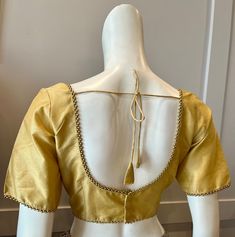 A golden color blouse Product details Fabric - silk blend Bust size 40" Waist 30" sleeve length 10" Can be tailored to fit 42" For extra charges Gold V-neck Blouse For Work, Traditional Gold V-neck Tops, Gold V-neck Blouse For Wedding, Gold Long Sleeve Top For Evening, Elegant Yellow Blouse Piece For Festive Occasions, Elegant Gold Tops For Formal Occasions, Elegant Gold Formal Tops, Elegant Fitted Gold Top, Elegant Gold Blouse For Workwear