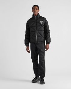 Black Re-nylon Down Jacket | PRADA Designer Nylon Outerwear For Outdoor, Nylon Puffer Jacket With Zip Cuffs, Winter Nylon Windbreaker With Zip Cuffs, Luxury Nylon Outerwear For Streetwear, Designer Black Nylon Outerwear, Functional Long Sleeve Outerwear With Zip Cuffs, Designer Nylon Outerwear For Fall, Functional Nylon Outerwear With Zip Cuffs, Nylon Outerwear With Zip Cuffs For Outdoor Use