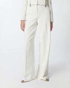 Elegant women's palazzo trousers in stretch crepe. Regular waist and wide leg, with French and welt pockets on the back, central pleat on both front and back. Zip fastening and small covered hook fastening. Modern White Wide Leg Pants For Formal Wear, Modern White Wide Leg Pants For Formal Occasions, Modern White Formal Wide Leg Pants, Tailored White Wide Leg Pants, Modern White Wide Leg Pants For Work, Elegant White Wide Leg Dress Pants, Elegant White Wide Leg Pants With Pressed Crease, White Full-length Wide Leg Office Pants, White Wide Leg Full Length Pants For Office